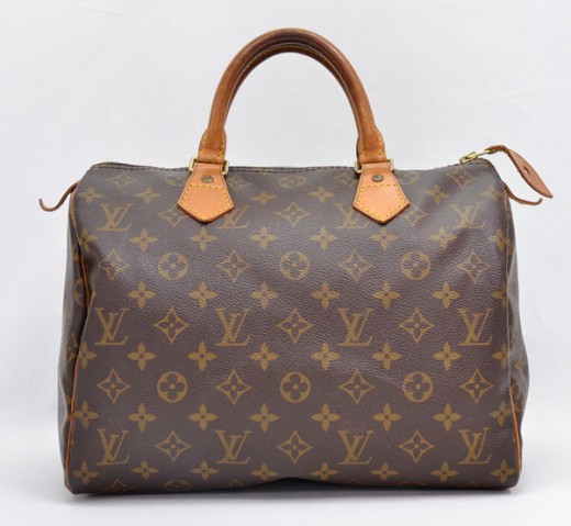 Louis Vuitton 12 years old bag developed a dark patina. . . and a black  stain.