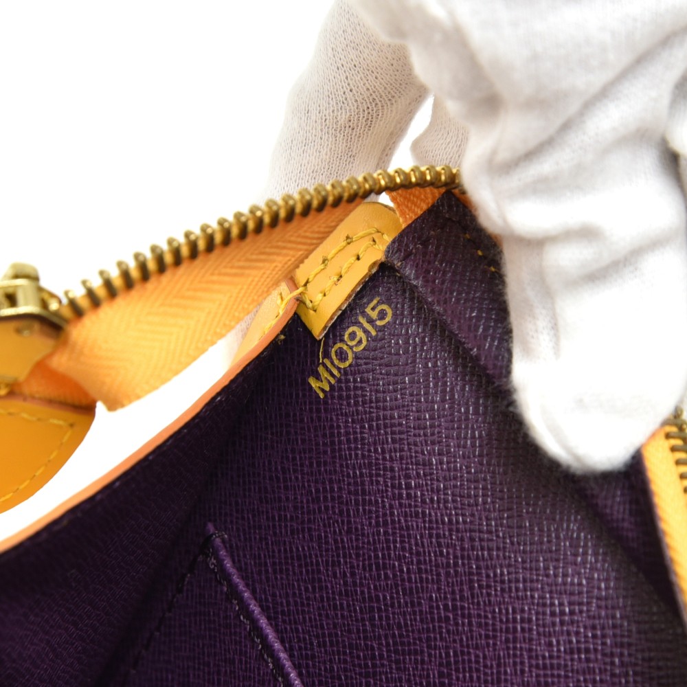 LOUIS VUITTON TASSIL YELLOW EPI LEATHER SAC TRIANGLE HANDBAG, geometric  shape, with purple leather lining, two top handles, zip closure at the top,  40cm x 16cm H x 14cm.